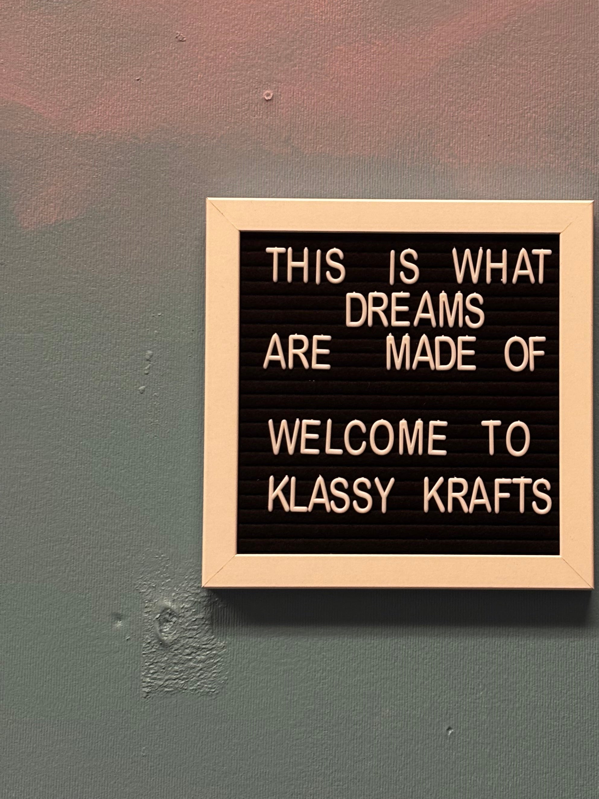 Decorative sign with motivational quote on a wall